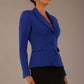 Model wearing the Melberry tailored jacket in royal blue, showing the sculpted waist and statement lapel detail.
