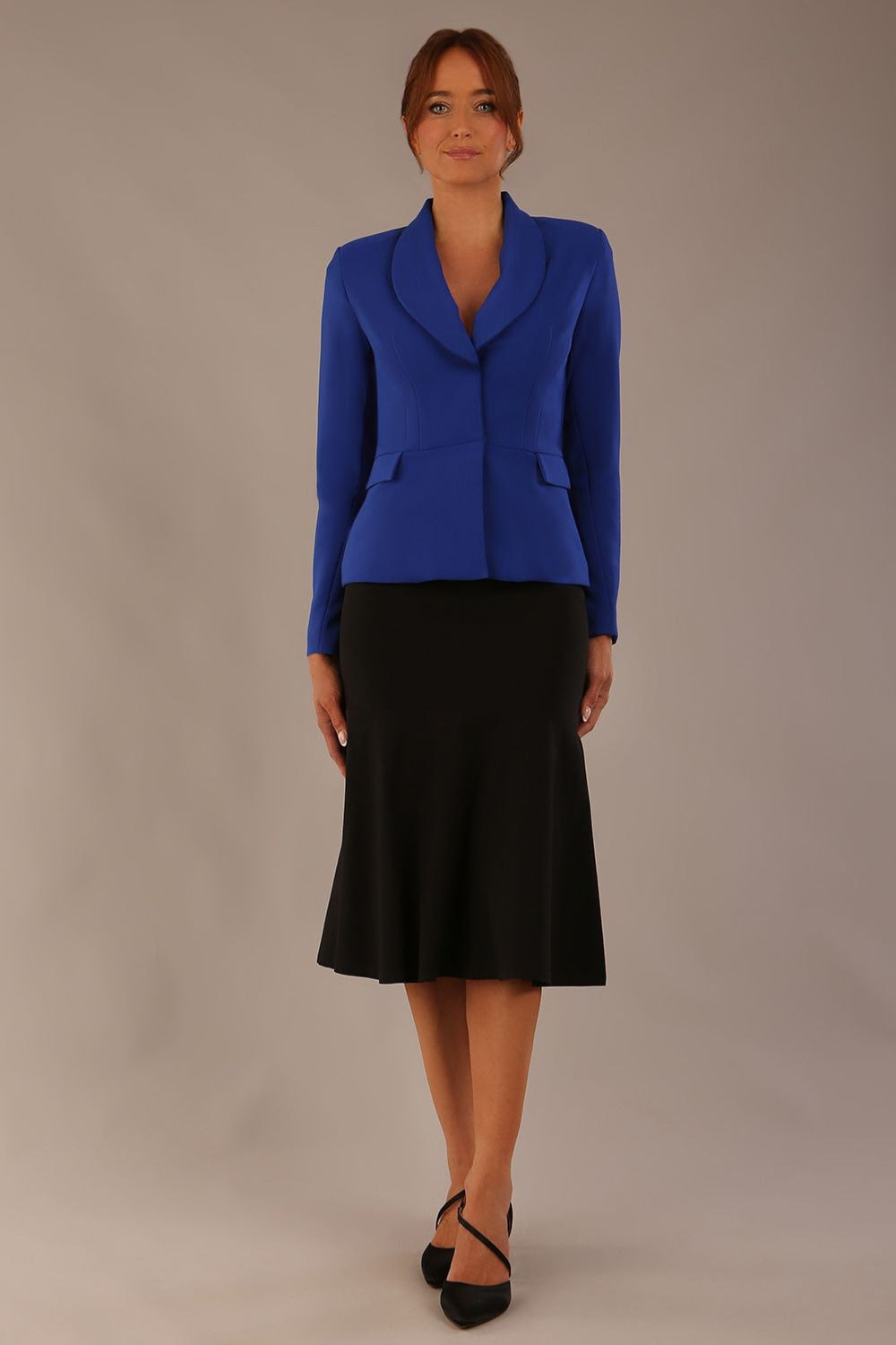 Model wearing the Melberry tailored jacket in royal blue, showing the sculpted waist and statement lapel detail.