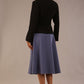 back view of the model wearing the black Melberry tailored jacket styled with the Harlow A-Line Skirt.