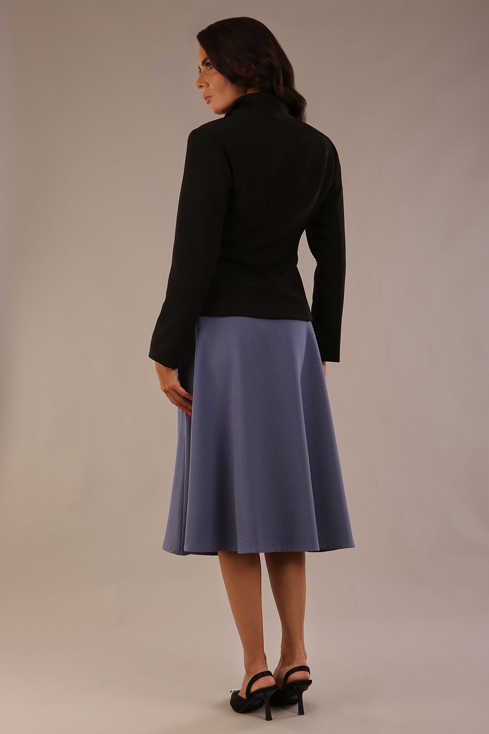 back view of the model wearing the black Melberry tailored jacket styled with the Harlow A-Line Skirt.