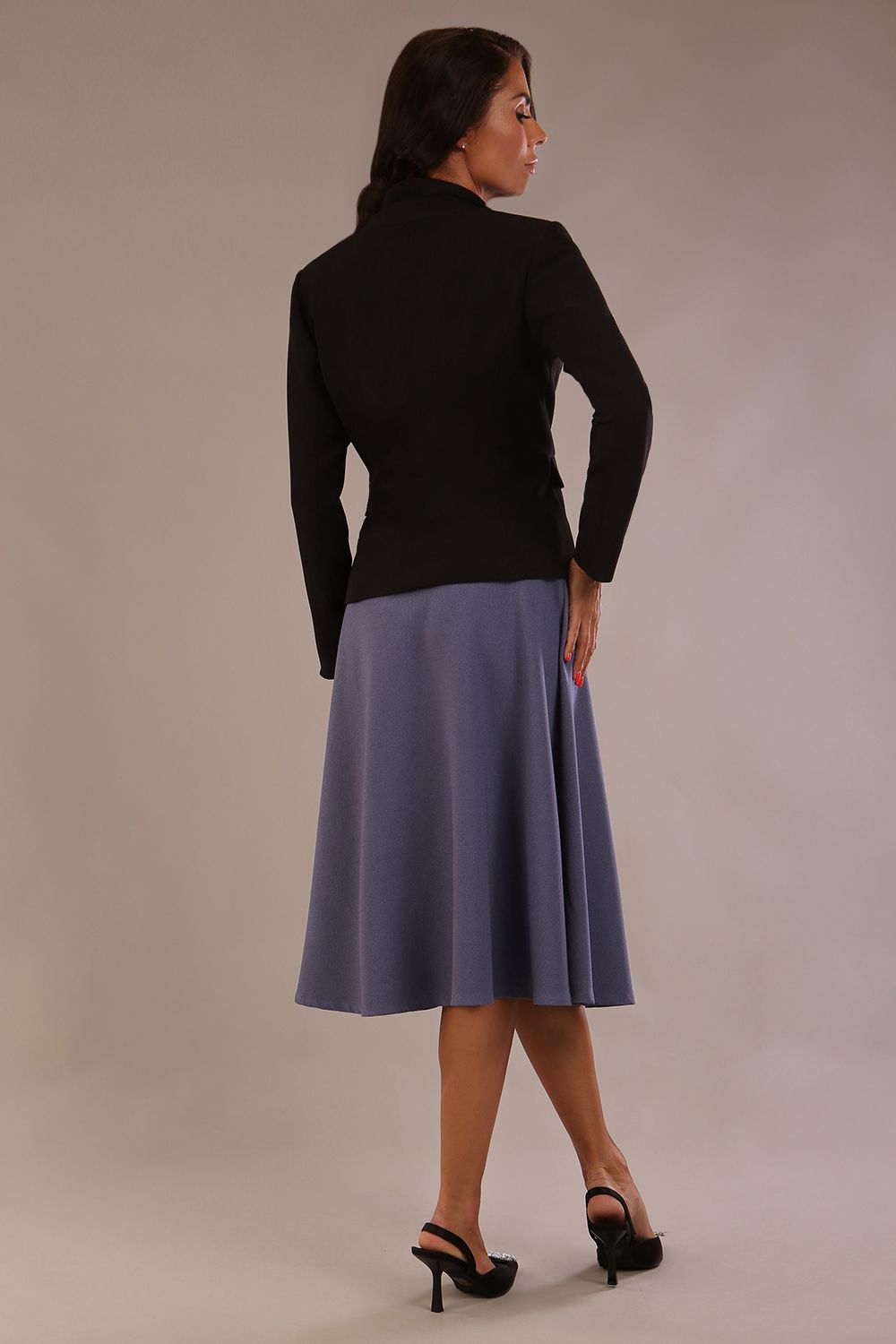 back view of the model wearing the black Melberry tailored jacket styled with the Harlow A-Line Skirt.
