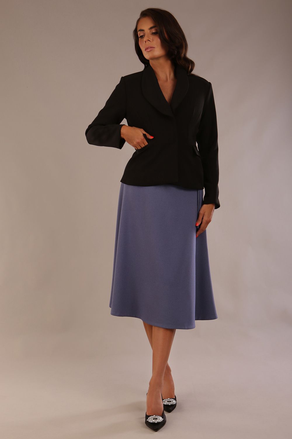 Close-up front view of the Melberry statement jacket in black, showing the flap pocket and fabric-covered buttons.