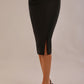 Close-up of the Claudette pencil skirt in black, highlighting the side button and pleating details.