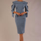 Model wearing the Rio statement collar pencil dress in blue mineral, showcasing its architectural silhouette.