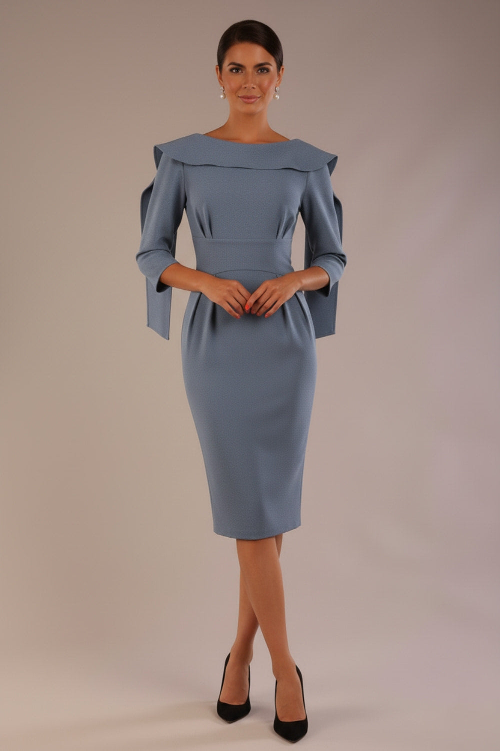 Model wearing the Rio statement collar pencil dress in blue mineral, showcasing its architectural silhouette.