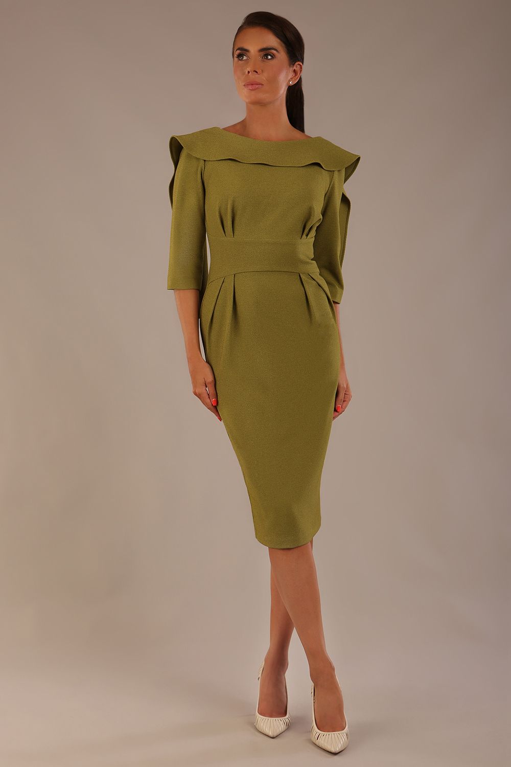 Model wearing the Rio statement collar pencil dress in oasis green, showcasing its architectural silhouette.