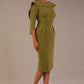 Model wearing the Rio statement collar pencil dress in oasis green, showcasing its architectural silhouette, side view