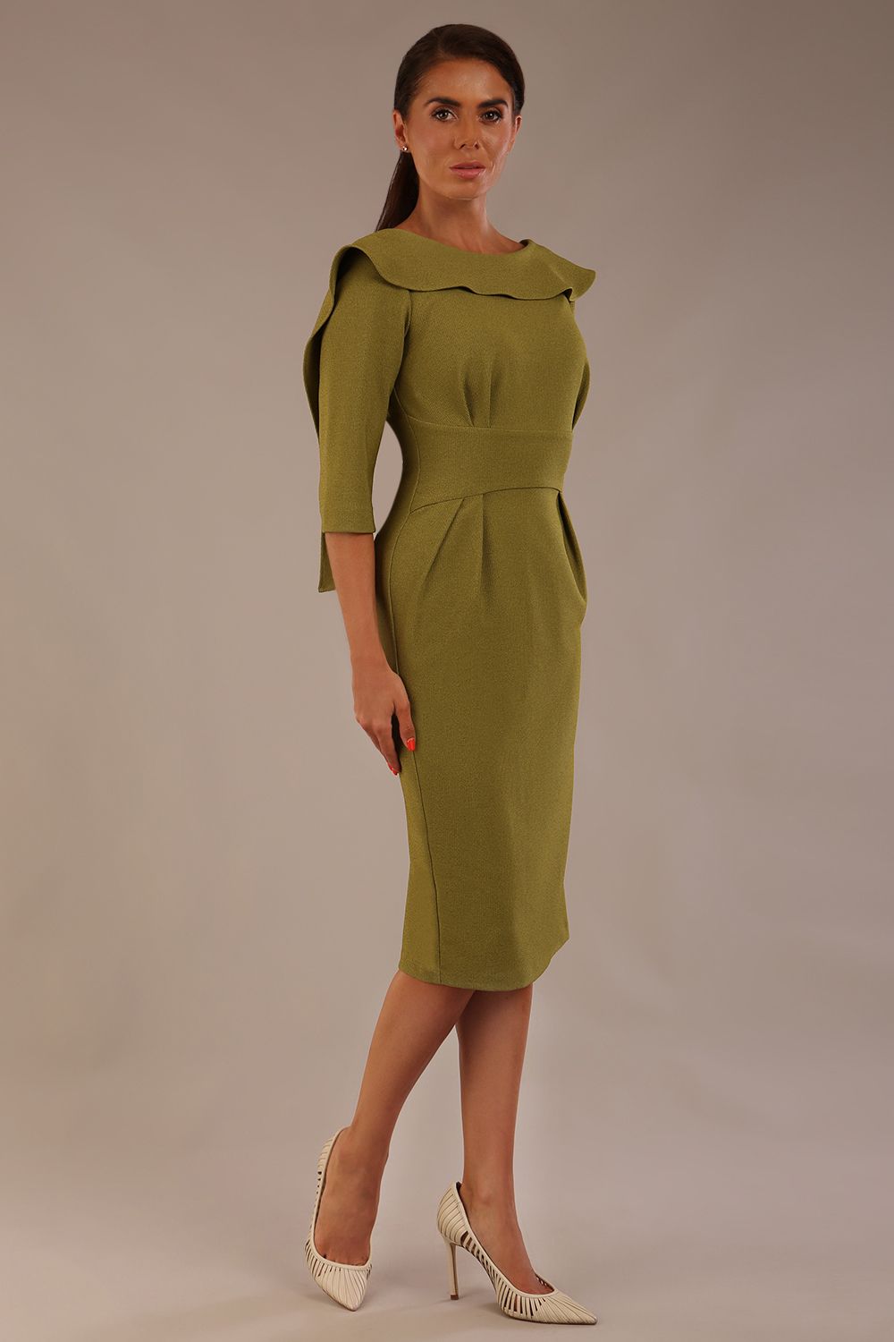 Model wearing the Rio statement collar pencil dress in oasis green, showcasing its architectural silhouette, side view