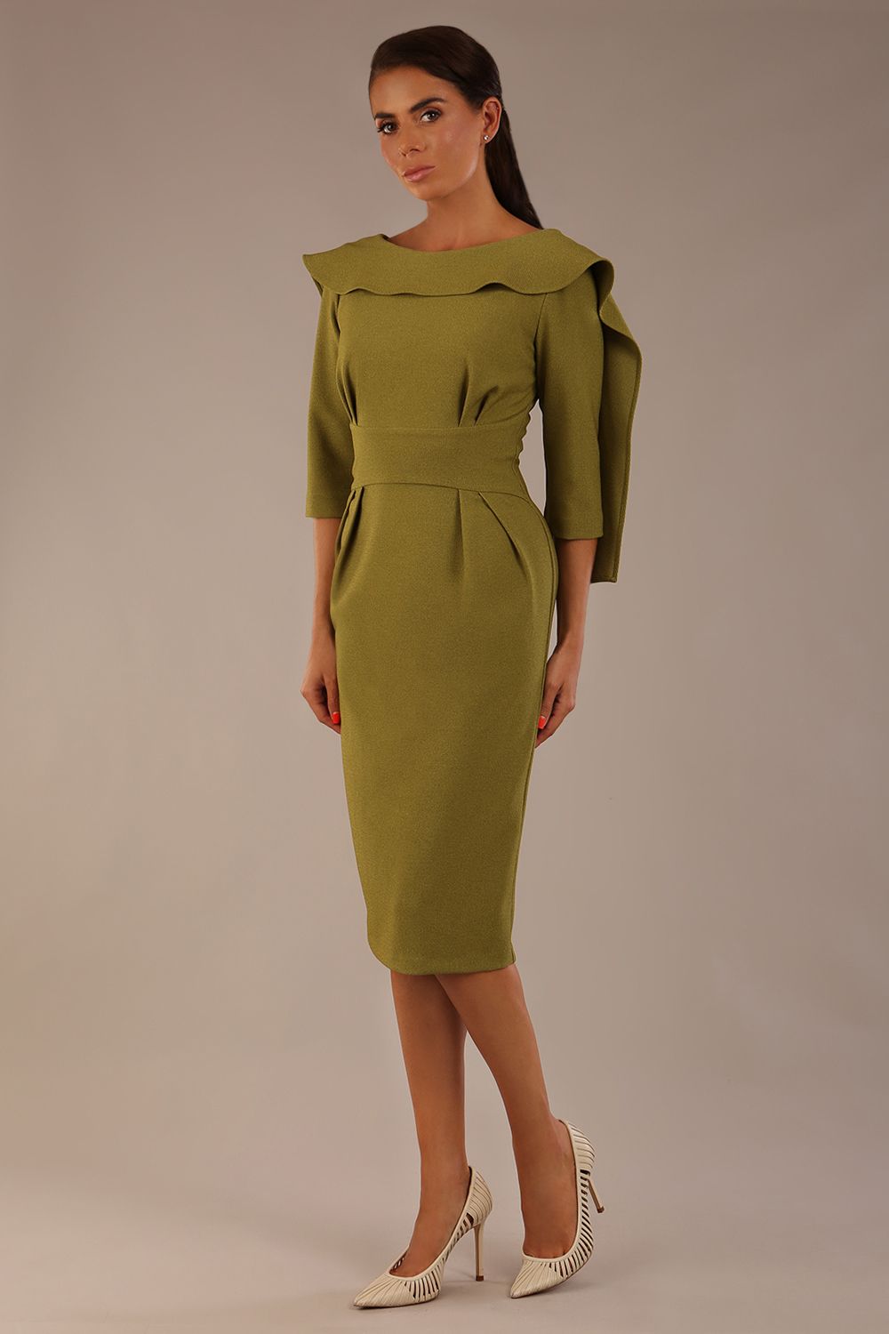 Model wearing the Rio statement collar pencil dress in oasis green, showcasing its architectural silhouette.