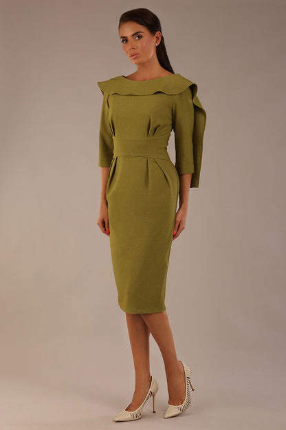 Model wearing the Rio statement collar pencil dress in oasis green, showcasing its architectural silhouette.