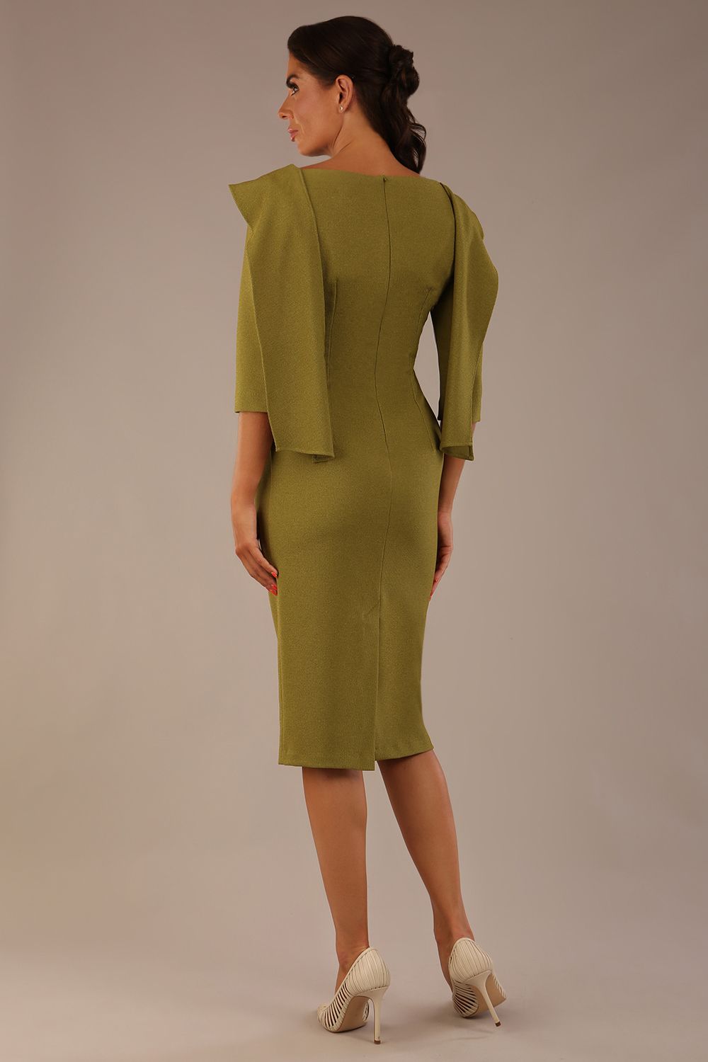 Model wearing the Rio statement collar pencil dress in oasis green, showcasing its architectural silhouette, back view