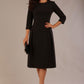 Model wearing the Ario pleated A-line dress in black, showcasing the round neckline and 3/4 sleeves.
