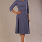 Model wearing the Ario pleated A-line dress in blue mineral, showcasing the round neckline and 3/4 sleeves.