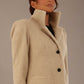 Model wearing the Ambrose boucle midi coat in pink tint, long sleeves teddy feeling with a collar neckline and 2 closure buttons at the front and pockets close up