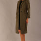 Model wearing the Ambrose boucle midi coat in olive green, long sleeves teddy feeling with a collar neckline and 2 closure buttons at the front and pockets