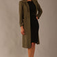 Woman wearing a long olive green Ambrose Boucle Midi Coat over a black Rialto sleeveless pencil dress on a plain background