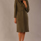 Model wearing the Ambrose boucle midi coat in olive green, long sleeves teddy feeling with a collar neckline and 2 closure buttons at the front and pockets (Olive Green)