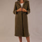 Model wearing the Ambrose boucle midi coat in olive green, long sleeves teddy feeling with a collar neckline and 2 closure buttons at the front