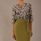 Model wearing a Suki asymmetric draped top in the Aurora Botanical print, styled with a olive green pencil skirt.
