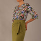 Model wearing a Suki asymmetric draped top in the Aurora Botanical print, styled with a olive green pencil skirt.