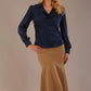 Blonde Model wearing the Shropshire top in navy blue, styled with a camel flared fishtail skirt