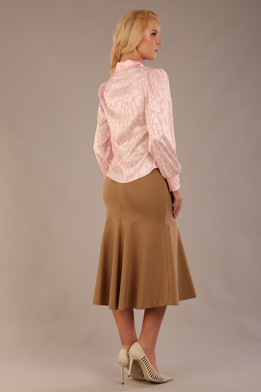 Blonde Model wearing the Shropshire top in pink, styled with a camel flared fishtail skirt