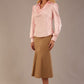Blonde Model wearing the Shropshire top in pink, styled with a camel flared fishtail skirt front