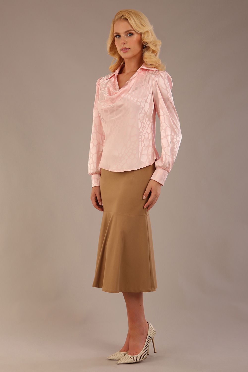 Blonde Model wearing the Shropshire top in pink, styled with a camel flared fishtail skirt front