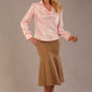 Blonde Model wearing the Shropshire top in pink, styled with a camel flared fishtail skirt