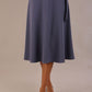 Model wearing the Harlow A-line midi skirt in blue mineral, with the side-tie fastened in a bow.
