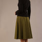 Model wearing the Harlow A-line midi skirt in oasis green, with the side-tie fastened in a bow with a black jacket back