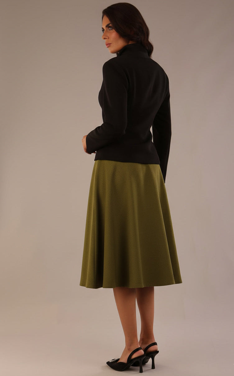 Model wearing the Harlow A-line midi skirt in oasis green, with the side-tie fastened in a bow with a black jacket back