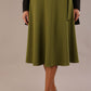 Model wearing the Harlow A-line midi skirt in oasis green, with the side-tie fastened in a bow.