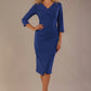 Model wearing the Adley asymmetric draped pencil dress in nautical blue