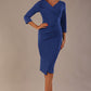 Model wearing the Adley asymmetric draped pencil dress in nautical blue