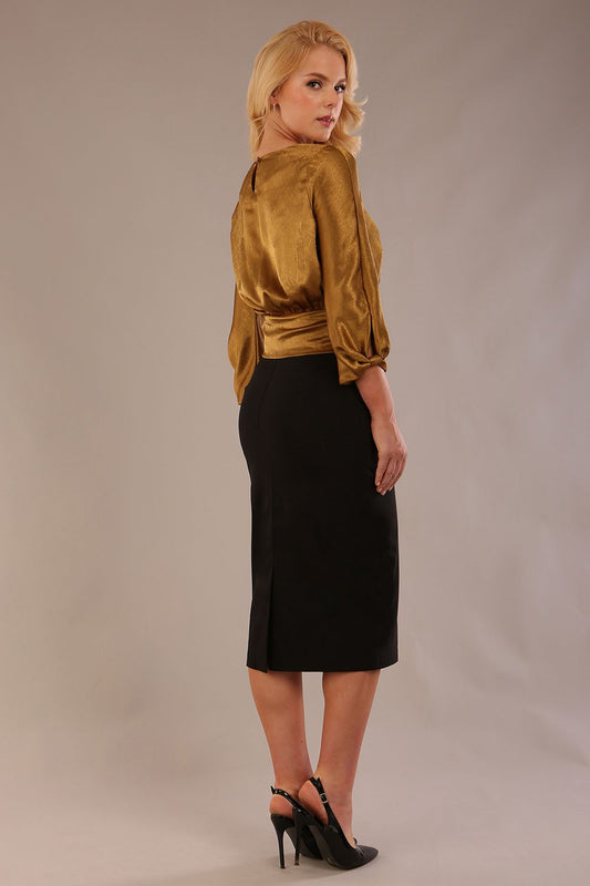 Model wearing a Hollywood lustre gold top with a blouson silhouette and a black pencil skirt back