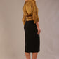 Model wearing a classic Ingrid pencil skirt in black with a sophisticated gold top