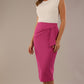 Model wearing in a Festive Fuchsia Hedy pencil skirt with a draped front and a sophisticated white top