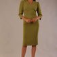 Model wearing an Ethan V-neck dress in oasis green, highlighting the flattering seams and puff shoulders.