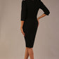 Model wearing a black Ethan pencil dress with a crossover V-neck and tailored seams, back view