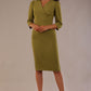 Model wearing an Ethan V-neck dress in oasis green, highlighting the flattering seams and puff shoulders.