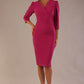 Model wearing an Ethan V-neck pencil dress in festive fuchsia, with 3/4 sleeves and puff shoulders.