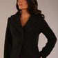 Model wearing the Teddy Luxe Boucle Jacket in black, showcasing its elegant shawl collar and textured fabric.