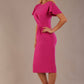 Model wearing magenta pink Finley midi pencil dress with ruched waist and split sleeves, front view.