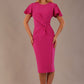 Model wearing magenta pink Finley midi pencil dress with ruched waist and split sleeves, front view.