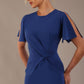 Model wearing nautical blue Finley midi pencil dress with ruched waist and split sleeves, close up view.