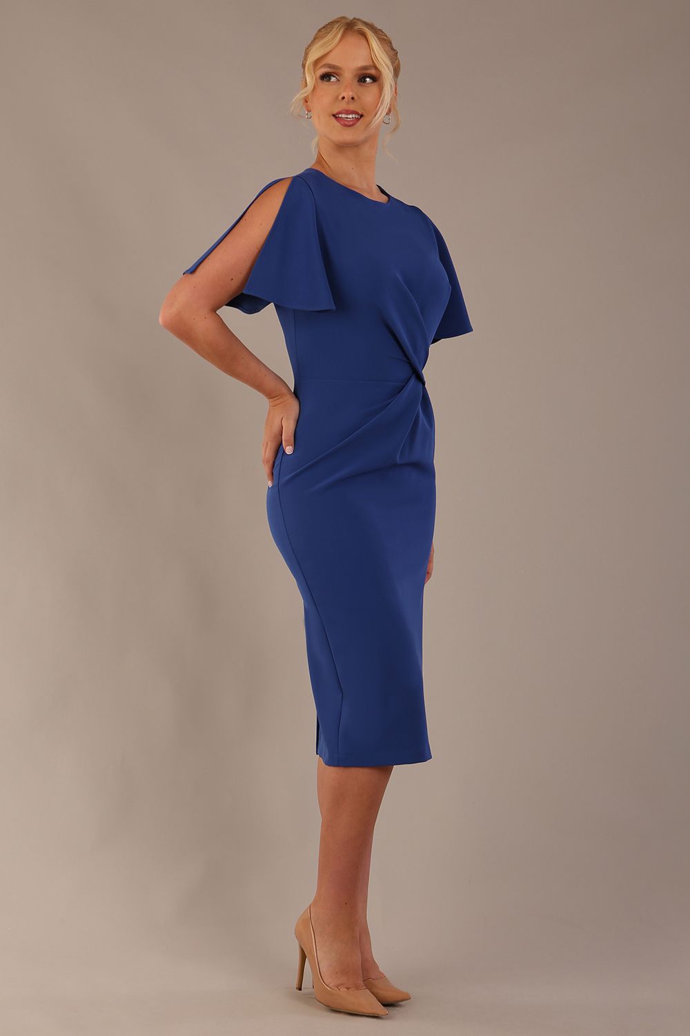 Model wearing nautical blue Finley midi pencil dress with ruched waist and split sleeves, side front view.