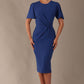 Model wearing nautical blue Finley midi pencil dress with ruched waist and split sleeves, front view.