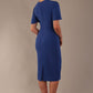 Model wearing nautical blue Finley midi pencil dress with ruched waist and split sleeves, back view.