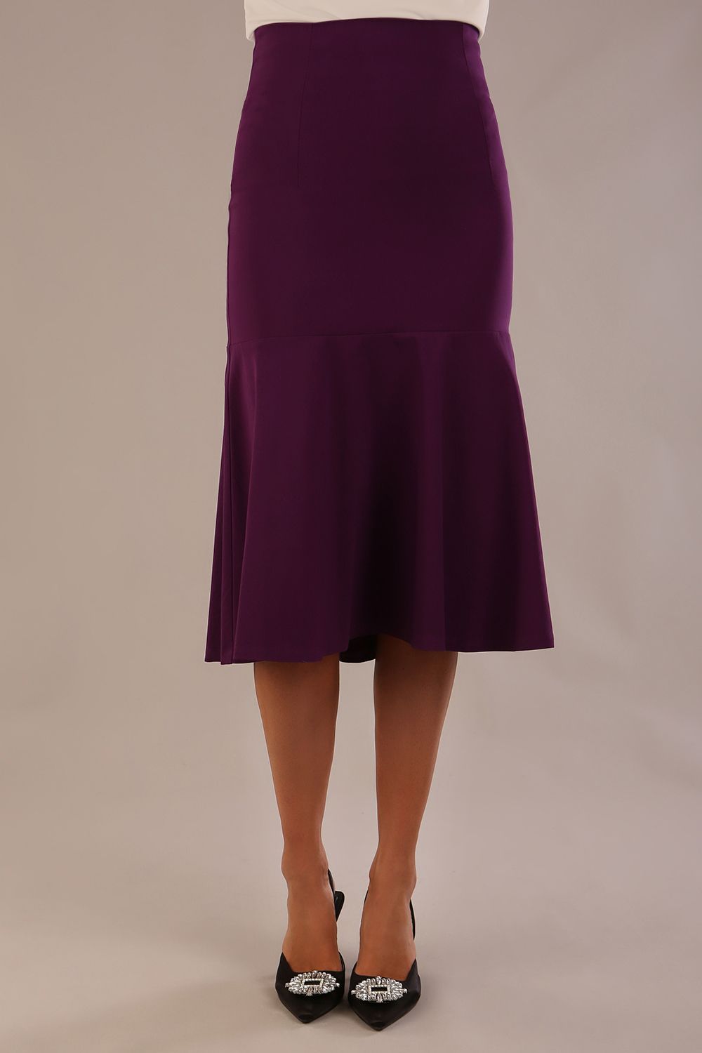 Model wearing a purple Marlene fishtail skirt, highlighting the silhouette.